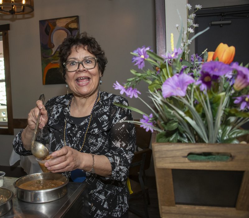 Mariachi owner Yolanda Pineda is serving customers gumbo.